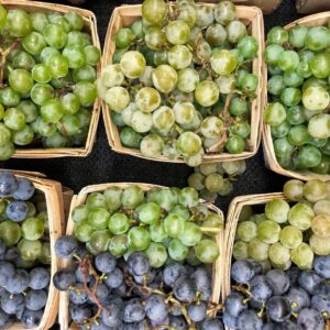 buckets of white and red grapes