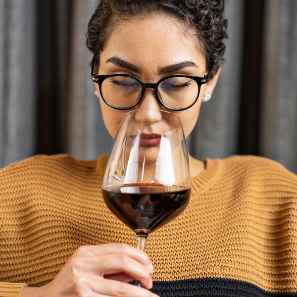 woman smelling wine